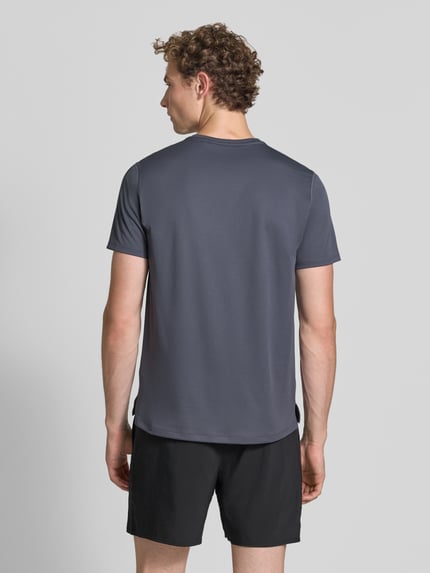 Männermodel trägt T-Shirt mit Logo-Print Modell 'CORE' von ASICS TIGER in Dunkelgrau, glatte Struktur, gerader Schnitt, Rückenansicht, Ganzkörperansicht Rückansicht.