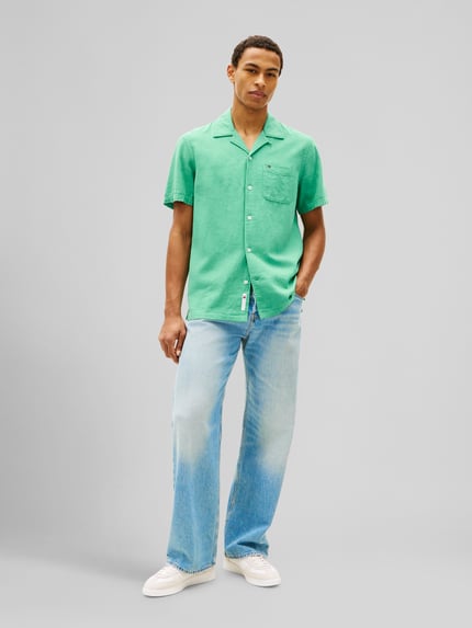 Männermodel trägt Regular Fit Freizeithemd aus Leinen-Baumwoll-Mix von Tommy Jeans, Optik: Unifarben, Flammgarn, Ganzkörperansicht von vorne.