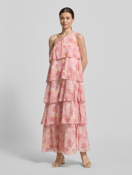 Frauenmodel trägt Ausgestelltes Maxikleid mit Rüschendetail Modell 'FELICIA' von Vero Moda in rosa floraler Chiffon-Optik, One Shoulder, Maxi-Länge, Ganzkörperansicht von vorne.