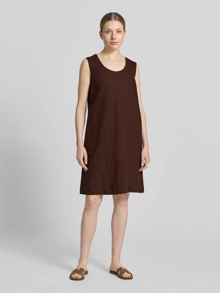 Frauenmodel trägt Knielanges Kleid aus Leinen-Viskose-Mix Modell 'LAVA' von FREE/QUENT in Braun, gerader Schnitt, Rundhalsausschnitt, glatte Textur, Ganzkörperansicht von vorne. Rückenlänge bei Größe S: 95 cm, Brustweite: 50 cm.