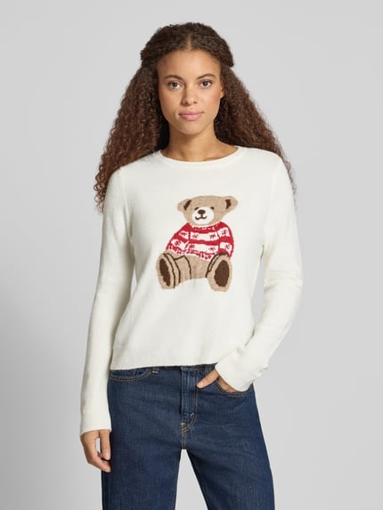 Frauenmodel trägt Rollkragenpullover mit Hundemotiv Weihnachten von ONLY in mehrfarbiger Strickoptik, Langarm, Motiv-Print, Nahaufnahme Oberkörper.