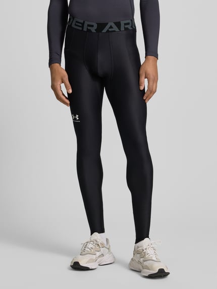 Männermodel trägt Leggings mit Beintasche von Under Armour, Elastischer-Material-Mix, enge Passform, Elastischer-Logo-Bund, Label-Print, Schwarz, Ganzkörperansicht von vorne.