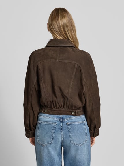 Vrouwenmodel draagt dames leerjack van Drykorn, Echt leer, straight fit, model 'MARWICK', kentkraag, knoopsluiting, borstzak met knoopsluiting, zijsteekzakken, donkerbruin, gladde structuur, Ganzkörperansicht Rückansicht.
