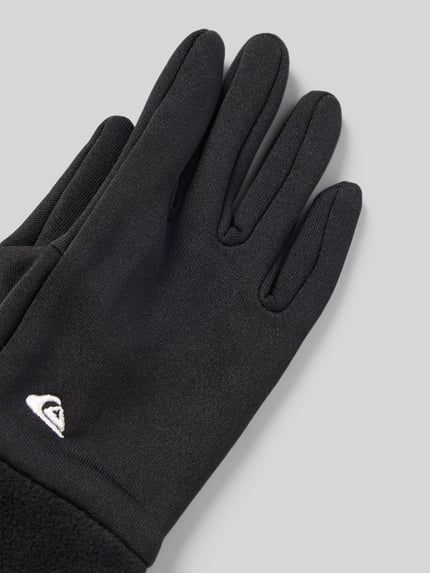 Produktfoto, czarne rękawiczki dziecięce Handschuhe mit Label-Stitching Modell 'HOTTAWA JR' od Quiksilver, materiał polarowy, zbliżenie na detal.
