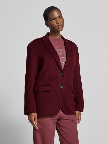 Frauenmodel trägt Regular Fit Kurzblazer mit Pattentaschen Modell 'QUINN' von Anine Bing in uni Dunkelrot, Struktur, Webware, Ganzkörperansicht von vorne.
