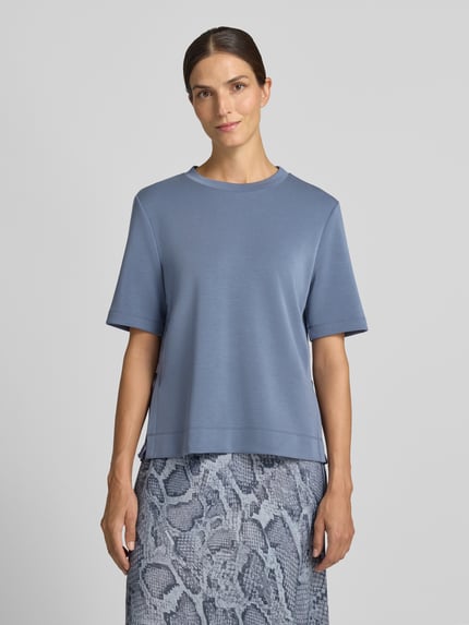 Vrouwenmodel draagt Sweatshirt mit Rundhalsausschnitt van Marc Cain in lichtblauw, elastische materiaalmix met viscose, recht model, ronde hals, halflange mouwen, gladde structuur, Ganzkörperansicht van voren.