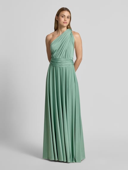 Vrouwenmodel draagt Maxikleid met diep V-hals van Rose Avenue, getailleerd model, gekruiste bandjes achter, tailleband, ruglengte maat S 135 cm, volledige lichaamsvooraanzicht.
