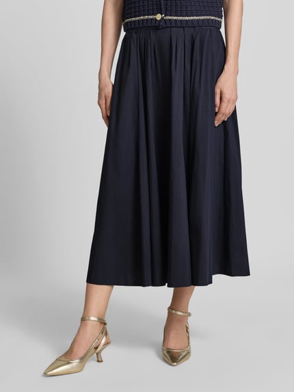 Kobiece modelka nosi Midirock mit gelegten Falten od ROBE LÉGÈRE, granatowy, bawełniany, krój A-linii, srebrzyste buty, szerokość w rozmiarze 36: 33 cm, długość całkowita: 81 cm, zdjęcie całej sylwetki z przodu.