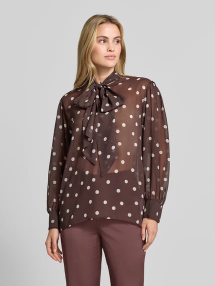 Vrouwenmodel draagt Relaxed Fit blouse in semi-transparant design van SWING, met Sierstrik en lange mouwen, Ruglengte maat 36: 68 cm, vooraanzicht busteshot.