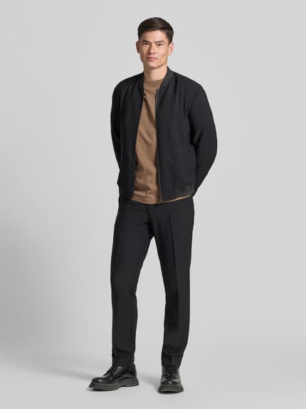 Męski model nosi Relaxed Fit T-Shirt aus reiner Baumwolle Modell 'ASPEN' od SELECTED HOMME, jasnobrązowy kolor, gładka faktura, całopostaciowy widok z przodu.