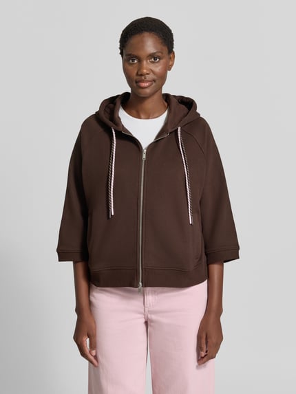 Vrouwenmodel draagt Oversized Sweatjacke mit doppeltem Kordelzug van Smith and Soul in bruin katoenmix met Raglanmouwen, tweewegritssluiting en capuchon, Ganzkörperansicht van voren.