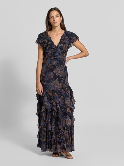 Frauenmodel trägt Eng anliegendes Abendkleid mit Rüschen von Lauren Ralph Lauren in Dunkelblau mit braunem Blumenmuster, Ganzkörperansicht von vorne. Damen Abendkleid von Lauren Ralph Lauren