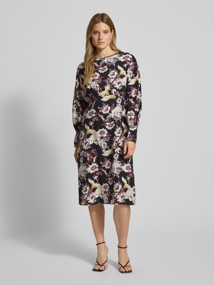 Modelka kobieca nosi Midikleid mit Rundhalsausschnitt Modell 'Orelia' od GUIDO MARIA KRETSCHMER WOMAN, czarny w kwiaty, luźny krój, widok z przodu.
