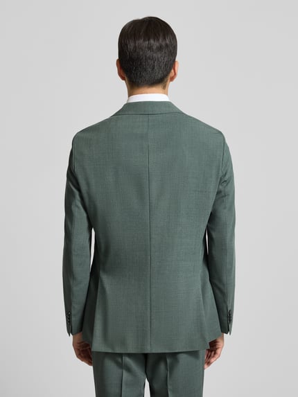 Männermodel trägt Slim Fit Sakko aus Schurwoll-Mix Modell 'HUTSON' von BOSS in grün, unifarben, Ganzkörperansicht Rückansicht.