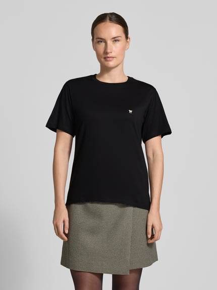 Frauenmodel trägt schwarzes Regular Fit T-Shirt aus reiner Baumwolle Modell 'VENACO' von Weekend Max Mara, dezentes Logo, Ganzkörperansicht von vorne.
