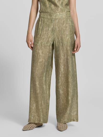 Frauenmodel trägt Wide Fit Stoffhose aus Lyocell-Mix von Jake*s Collection in Grün mit Falten-Optik, floraler Allover-Print, elastischer Bund, Nahaufnahme Oberkörper.