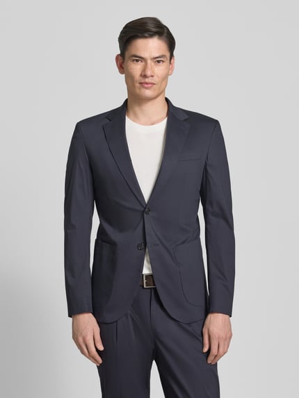 Männermodel trägt Sakko mit Reverskragen Modell 'Dallas' van JOOP! collectie, katoenmix, regular fit, paspelzak op de borst, steekzakken, knoopsluiting, donkerblauw, glad oppervlak, Ganzkörperansicht van voren.