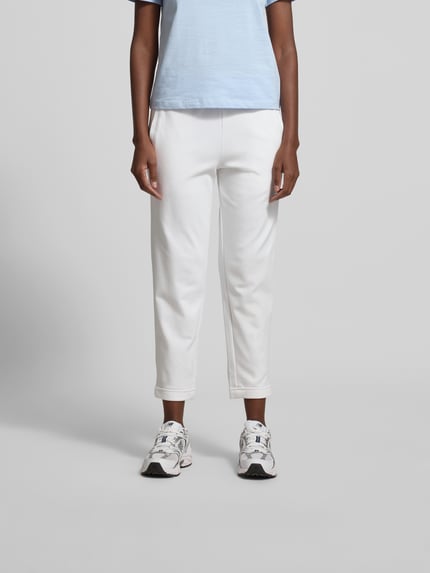 Vrouwenmodel draagt Sweatpants aus Baumwoll-Mix van Juvia in gebroken wit, smal toelopend been, elastische tailleband met trekkoord, steekzakken, elastische boorden, katoen-modal mix, maat S, volledige lichaamsvoorzijde.