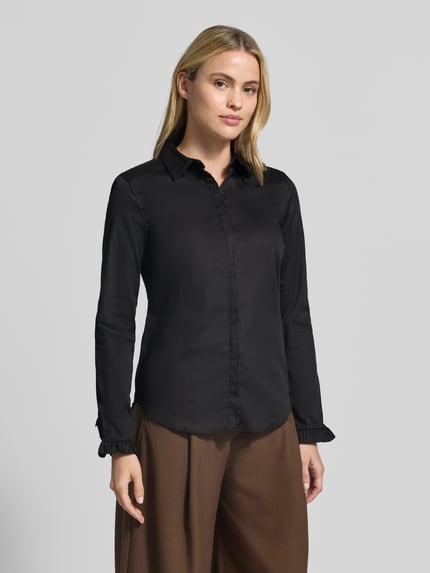 Frauenmodel trägt Hemdbluse aus Baumwoll-Mix Modell 'Mattie' von MOS MOSH in Schwarz, glatte Oberfläche, Rüschen an Ärmeln, Ganzkörperansicht von vorne. Elastischer Baumwoll-Mix, Slim Fit, durchgängige Knopfleiste, Hemdblusenkragen, abgerundeter Saum, Rückenlänge 70 cm, Ärmellänge 62 cm.