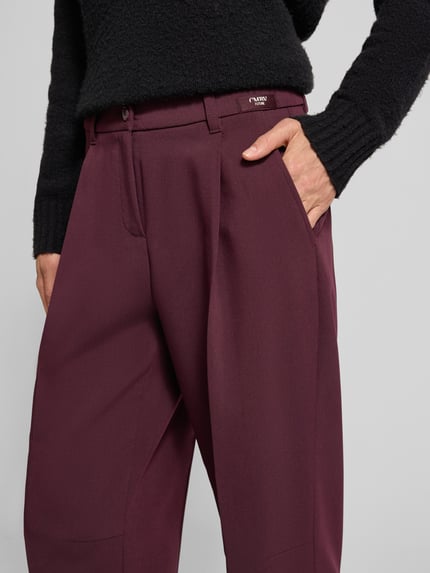 Männermodel trägt Cropped Barrel Leg Hose mit Bundfalten Modell 'Ortensia' von CAMBIO, unifarben, webstruktur, nahaufnahme oberkörper.