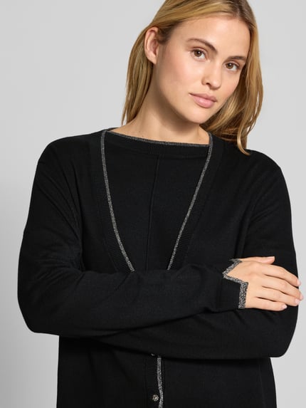 Frauenmodel trägt Relaxed Fit Cardigan aus Viskose-Mix Modell 'Aperta' von Liu Jo White in Schwarz mit silbernen Zierdetails, Nahaufnahme Oberkörper.