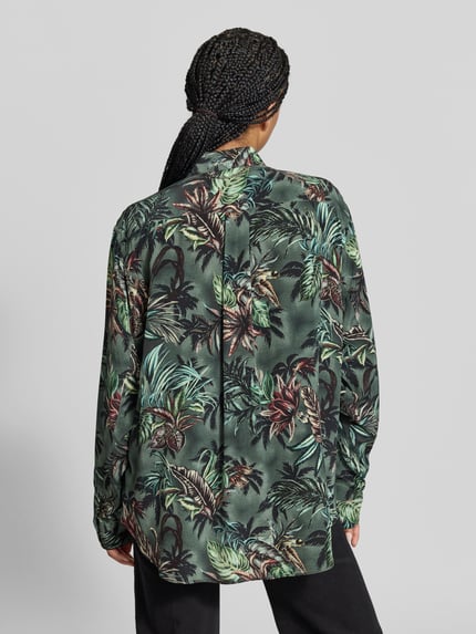 Frauenmodel trägt Hemdbluse mit floralem Allover-Print von Rabanne in Grün- und Brauntönen, Relaxed Fit, Langarm, Nietenbesatz, Ganzkörperansicht Rückansicht.