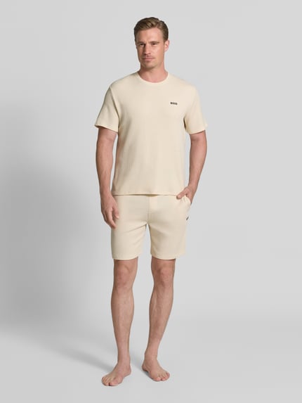Männermodel trägt Regular Fit T-Shirt aus Baumwoll-Mix von BOSS, unifarben, Waffelstruktur, kurzarm, Rundhals, Ganzkörperansicht von vorne.