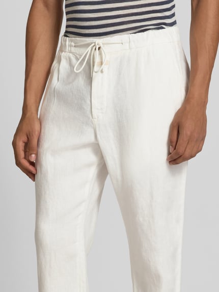 Männermodel trägt Tapered Fit Leinenhose van closed, zuiver linnen, steekzakken, achterzakken, elastische band met tunnelkoord, Nahaufnahme Oberkörper.