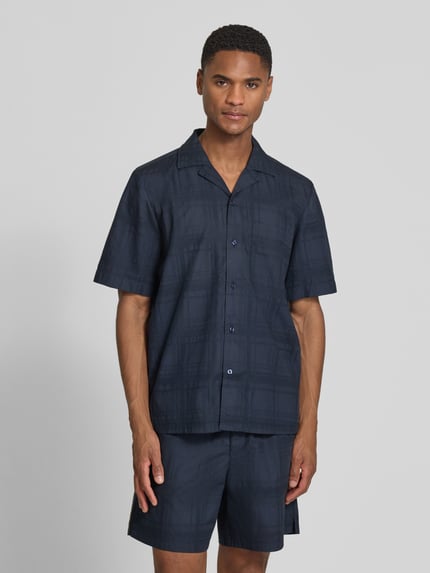 Męski model nosi Regular Fit Freizeithemd aus reiner Baumwolle Modell 'RAYER_M' von BOSS Orange, jednokolorowy, kołnierz z połami, jednorzędowa listwa guzikowa, krótki rękaw, brustasza, faktura, aplikacja z marką, materiał: bawełna, Ganzkörperansicht von vorne.