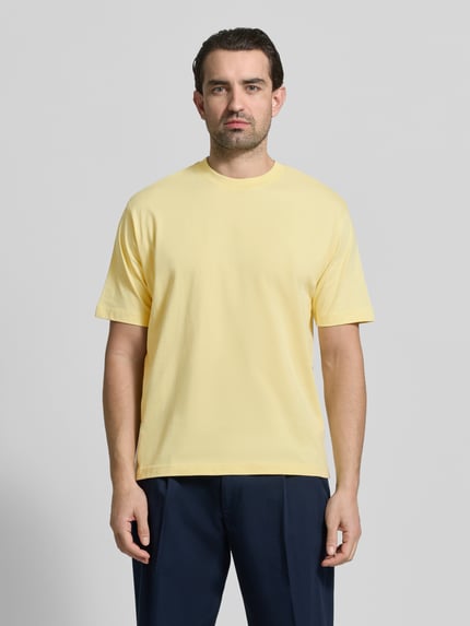 Männermodel trägt Regular Fit T-Shirt aus reiner Baumwolle von MCNEAL in Gelb, Rundhalsausschnitt, Kurzarm, Ganzkörperansicht von vorne.