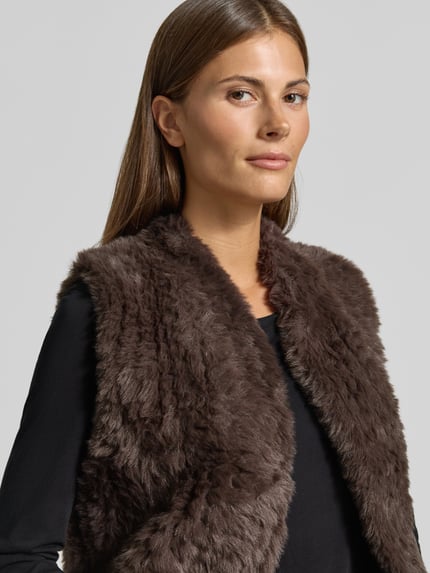 Vrouwenmodel draagt Regular fit bodywarmer van imitatiebont van comma, donkerbruin, mouwloos design, opstaande kraag, Nahaufnahme Oberkörper, Ruglengte maat S: 58 cm, Schouderbreedte: 37 cm, Borstwijdte: 48 cm.