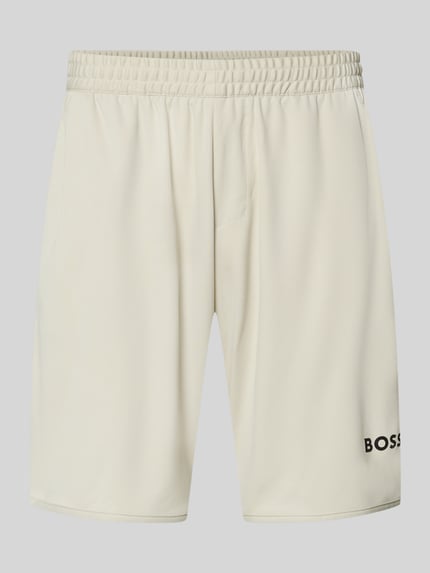 Produktfoto, Regular Fit korte broek met labelopschrift Model 'TOC SPIN 9 INCH' van BOSS Green, effen kleuren, elastische boord, zij-steekzakken, logodetail, tunnelkoordsluiting.