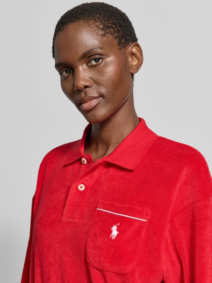 Frauenmodel trägt Regular Fit Poloshirt aus Baumwoll-Mix von Polo Ralph Lauren in Rot, Optik: Unifarben, Logo-Stitching, Kontrastpaspel, Polokragen, Langarm, Materialverarbeitung: Frottee, Nahaufnahme Oberkörper.