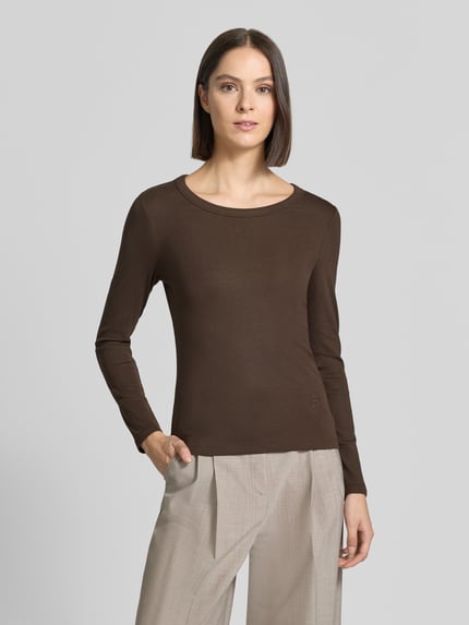Frauenmodel trägt Regular Fit Langarmshirt aus Baumwoll-Mix von Oui in Dunkelbraun, Rundhalsausschnitt, dezente Label-Stickerei, glatte Textur, Damen Langarmshirt von Oui, Ganzkörperansicht von vorne.