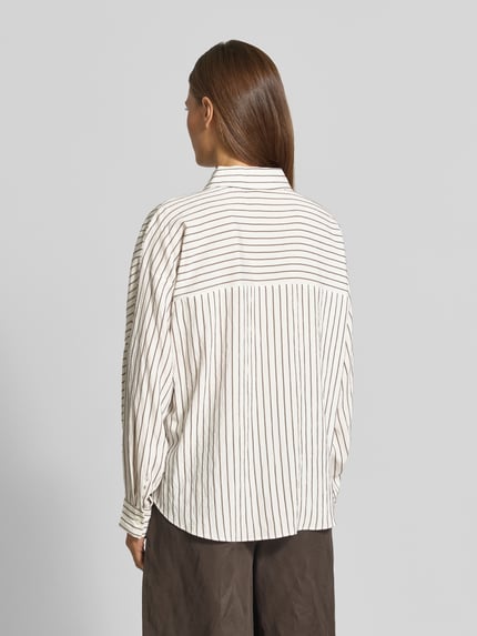 Frauenmodel trägt Loose Fit Langarmbluse aus Viskose Mix Modell 'Foha' von OPUS in Creme mit feinen schwarzen Streifen, Ganzkörperansicht Rückansicht, Damen Langarmbluse von OPUS.