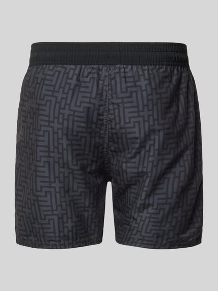 Produktfoto, Regular Fit Badeshorts mit Tunnelzug Modell 'Nelson' von FIRE + ICE für Herren mit geometrischem Allover-Print, elastischer Bund, Rückansicht, glatte Stofftextur, dunkle Grautöne.