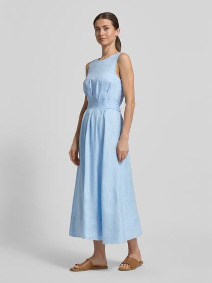 Frauenmodel trägt Cocktailkleid aus Leinen Modell 'Rosie' von Forever New, hellblau, taillierter Schnitt, Midikleid, Ganzkörperansicht von vorne.