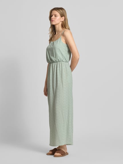 Vrouwenmodel draagt maxi-jurk uit crêpe model 'WINNER LIFE' van Only, all-over bloemenmotief, getailleerd, maxi, ronde hals, verstelbare spaghettibandjes, elastische tailleband, materiaalverwerking: crêpe, zijaanzicht, bijna volledige lichaamsopname.