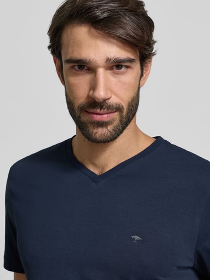 Männermodel trägt T-Shirt met Label-Stitching van Fynch-Hatton in donkerblauw, katoen, regular fit, geribde V-hals, Nahaufnahme Oberkörper.
