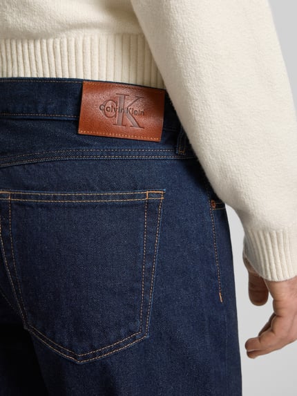Mannenmodel draagt 'Jeans mit 5-Pocket-Design' van Calvin Klein Jeans, donkerblauw, rechte pasvorm, detailopname achterkant.