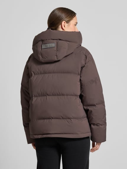 Frauenmodel trägt Jacke in Stepp-Optik mit Reißverschluss Modell 'Jilly Hope' von MOS MOSH in Braun, Kapuze mit Tunnelzug, Rückenlänge 63 cm, Schulterbreite 50 cm, Brustweite 58 cm, Ärmellänge 64 cm, Regular Fit, Ganzkörperansicht Rückansicht.