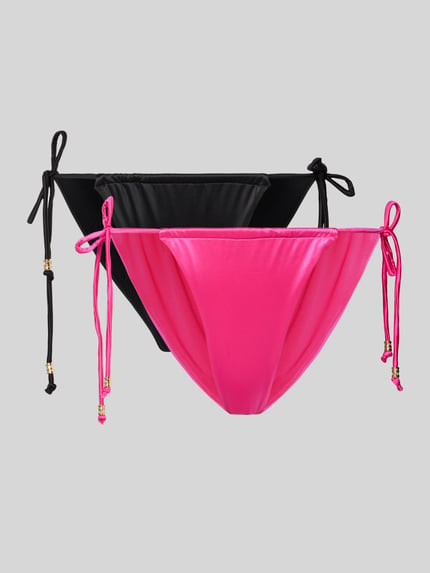 Produktfoto, Bikini-Slips im 2er-Pack mit seitlicher Schnürung Modell 'AMNESIA' von DORINA, Schwarz und Pink, glatte Stretch-Oberfläche.