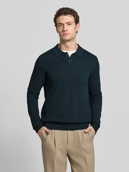Männermodel trägt Pullover mit Polokragen von MARC O'POLO in Dunkelblau, Regular Fit, Strickoptik, Logo-Stitching, Ganzkörperansicht von vorne.