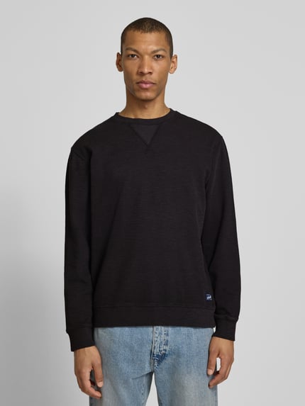 Männermodel trägt Regular Fit Sweatshirt mit Rundhalsausschnitt von Scotch & Soda, Baumwoll-Mix, Label-Detail, dunkle Farbe, Ganzkörperansicht von vorne. Rückenlänge bei Größe M: 68 cm, Ärmellänge bei Größe M: 65 cm.