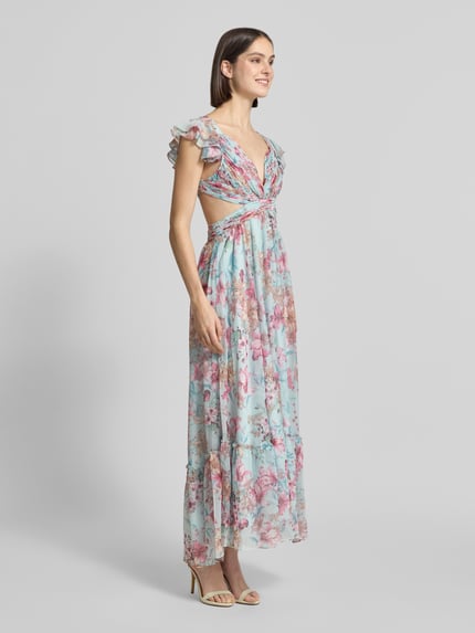Frauenmodel trägt Regular Fit Maxikleid mit floralem Allover-Print von ADLYSH, Tailliert Passform, Cut-Out, Kappärmel, Rüschen-Optik, Schnürverschluss, Falten-Optik, zarte Pastellfarben, luftige Textur, Ganzkörperansicht von vorne.