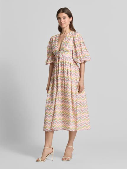 Frauenmodel trägt Cocktailkleid im Allover-Look mit 3/4-Arm von LACE & BEADS aus Reiner Baumwolle, A-Linie, Midikleid, V-Ausschnitt, Farbe mehrfarbig, Textur zart, Ganzkörperansicht von vorne.