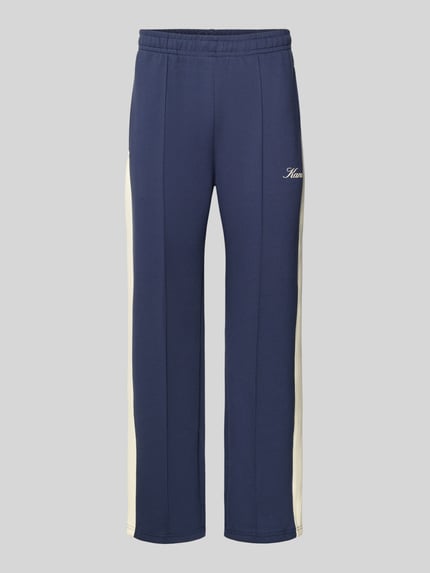 Produktfoto, Sweatpants mit Längsnähten und Label-Print von KARL KANI, dunkelblau mit weißen Seitenstreifen, elastischer Bund, Baumwoll-Mix