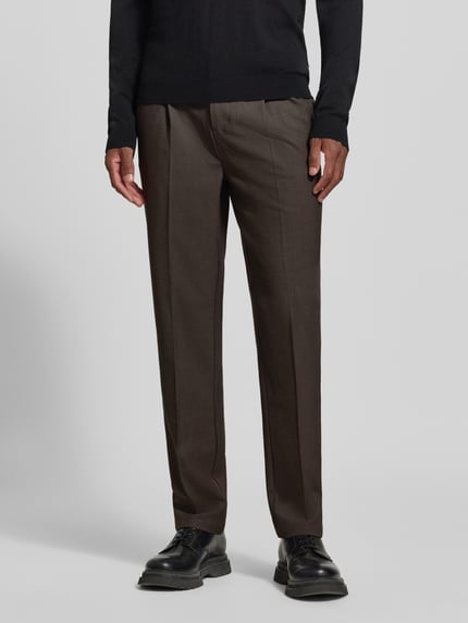Männermodel trägt Hose mit elastischem Bund und Bügelfalten Modell 'MARC 2.0' von Casual Friday, Material-Mix braun, Nahaufnahme Oberkörper. Regular Fit, seitliche Eingrifftaschen, Paspeltaschen hinten, leichte Textur.