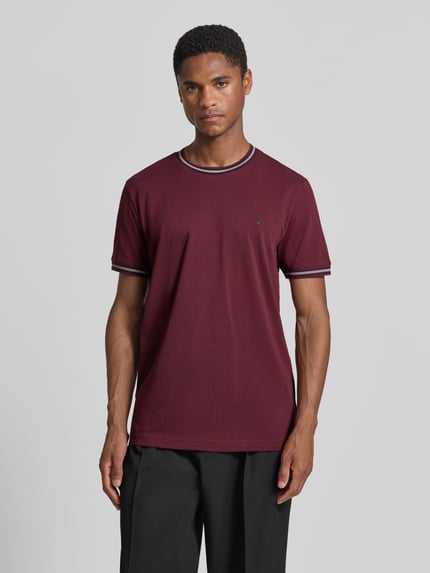 Männermodel trägt Regular Fit T-Shirt mit Logo-Stitching von Christian Berg Men in Bordeaux, Reine Baumwolle, Rundhalsausschnitt, Ganzkörperansicht von vorne. Rückenlänge bei Größe M: 71 cm.