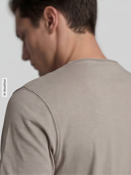 Männermodel trägt Regular Fit T-Shirt mit V-Ausschnitt von MCNEAL, reine Baumwolle, Rollsaum, Detailaufnahme Rückenansicht.